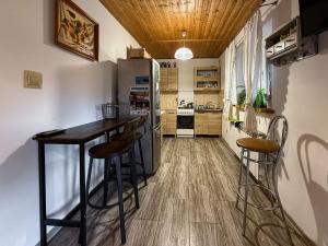 a kitchen with a table and a refrigerator at Kwatery u Anety in Ustrzyki Górne