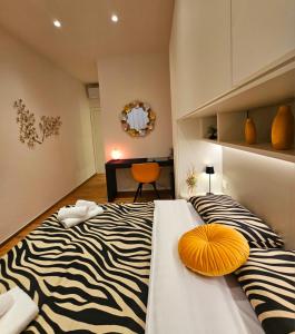 a zebra print bed in a room with a desk at Salotto Corso Garibaldi in Piacenza