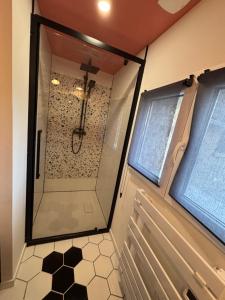 a shower with a glass door in a bathroom at Le refuge des Amoureux in Briord +13 photos