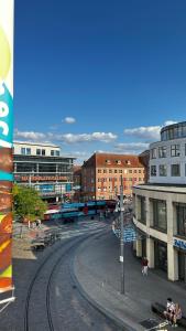 a view of a city with buildings and a train track at Modernes Apartment am Marienplatz, Schwerin in Schwerin