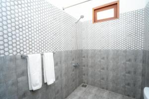 a bathroom with a shower with white towels at Kandy Grand Hill in Kandy