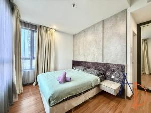 a bedroom with a large bed with purple pillows at i-City Shah Alam Residences by ASDEH Suites in Shah Alam +77 photos