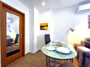 a small living room with a table and a couch at Porto River Sunset 1st in Vila Nova de Gaia