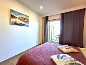 a bedroom with a bed and a large window at Porto River Sunset 1st in Vila Nova de Gaia