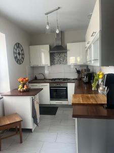 a kitchen with white cabinets and a counter top at Dom na Zdrowiu in Łódź