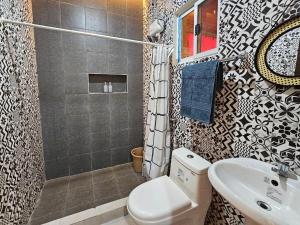 a bathroom with a toilet and a sink and a shower at Amado Transient Inn in Prado +30 photos
