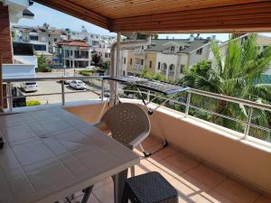 a balcony with a table and a view of a street at Garden Prizma Apart in Kemer