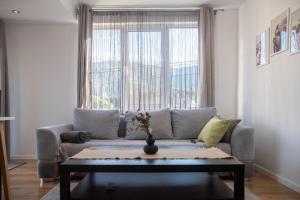 ein Wohnzimmer mit Sofa und Tisch in der Unterkunft Hyggemate - 1 Bed Room Cozy Apartment in Sarnitsa in Sarnitsa