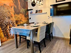a dining room with a table and a leopard mural at B&B Tina in Sneek