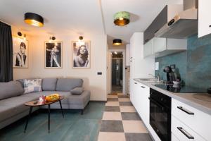 a kitchen and living room with a couch and a table at Villa Anabella III in Zadar