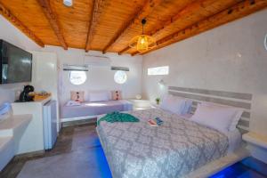 a bedroom with a bed and a sink and a tub at SantoriniNY in Perissa