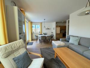 a living room with a couch and a table at Meeresrauschen 03 in Neuhaus
