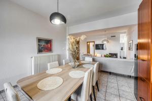 a dining room with a wooden table and chairs at Blue Ribbons luxury house in Ouranoupoli