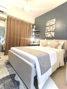 a bedroom with a large bed in a room at Simple Haven at Inspiria Davao Beside Abreeza Mall - Fully Equipped Studio by Rico in Davao City +17 photos