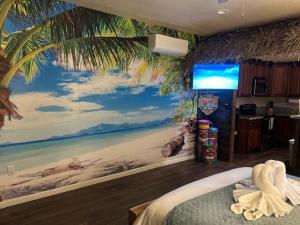 a bedroom with a mural of a beach at Beach House Staycation in Sparks