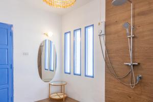 a bathroom with a shower and a mirror at Archie Village in Hinkong