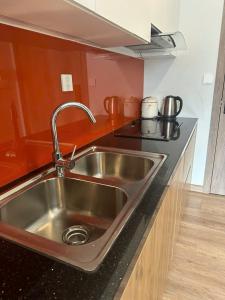a kitchen with a stainless steel sink in a kitchen at SP Sky OASIS 27 06 QuynhDao HomeStay in Kim Quan +12 photos