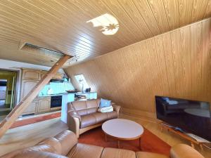 un salon avec un canapé, une table et une télévision dans l'établissement Ruhiges Stadtdomizil - Wohnkomfort in der Vier-Tore-Stadt, à Neubrandenbourg