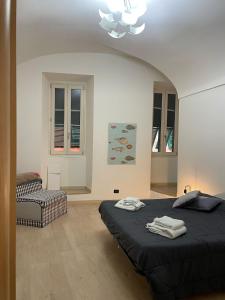a bedroom with a bed and a chair in it at Casa Luna in Ventimiglia