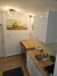 a kitchen with a sink and a counter top at Apartment Maja - Strict center of Zagreb in Zagreb