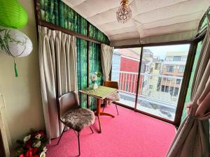 a room with a table and a large window at 桜の宿-大阪城Osaka castle-105m2 private-5Way access-KIX USJ 難波心斎橋 Direct in Osaka