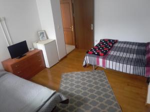 a living room with two beds and a table at Garsoniera in Ocniţa
