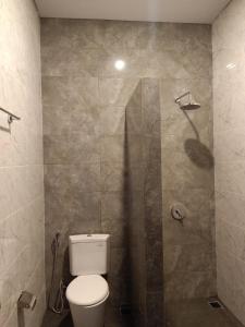 a bathroom with a toilet and a shower at n&d guest house in Canggu