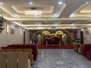 a banquet hall with a couch and a stage at Hotel Shree Radhe & Banquet in Darbhanga