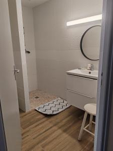 a bathroom with a sink and a mirror at Hotel Marjolaine in Roullet +18 photos