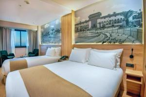 a hotel room with two beds and a painting on the wall at ADAY Hotel Casablanca in Casablanca +31 photos