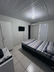 Ένα ή περισσότερα κρεβάτια σε δωμάτιο στο Hotel e pousada JRM