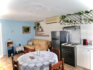 a kitchen with a table and a kitchen with a refrigerator at Pomegranate Seaside Corner in Fanari