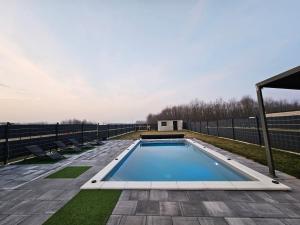 a swimming pool on the roof of a house at Villa Joy with Pool,Jacuzzi,E Auto Station in Sračinec