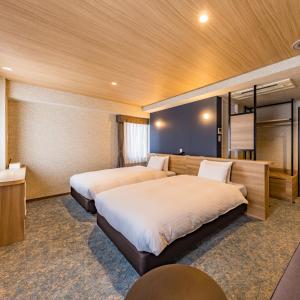Ένα ή περισσότερα κρεβάτια σε δωμάτιο στο Fukuoka Toei Hotel
