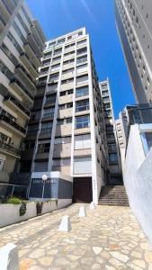 a large apartment building with a patio in front of it at Güemes y la costa in Mar del Plata
