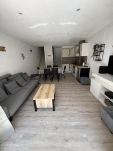a living room with a couch and a coffee table at maison 6 personnes villa sofia in Sainte-Maxime