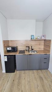 a kitchen with a sink and a counter top at 1 комнатные апартаменты in Semey