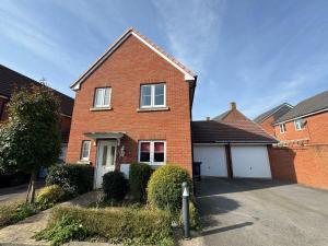 a red brick house with a white garage at Hanwell House SN25 Long Stays Sleep 5 Free Parking in Swindon
