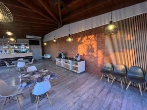 a room with a table and chairs and a brick wall at MOTEL S5 in Zbrachlin