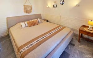 a bed in a room with a table at Michele Marie apts in Agia Pelagia