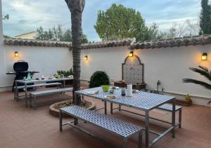 a patio with a table and benches in a yard at Spacious Villa with Exceptional Views in Malaga in Casarabonela