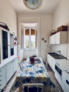 a kitchen with a table and a sink at La Piattaforma la tua casa con accesso diretto a mare in Santa Cesarea Terme +35 photos