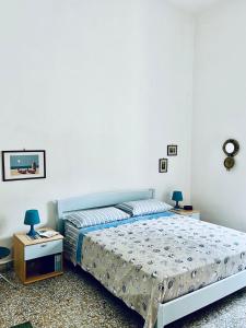 a bedroom with a bed and two night stands at La Piattaforma la tua casa con accesso diretto a mare in Santa Cesarea Terme