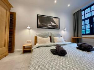 a bedroom with a bed with two pillows on it at Urban Design Loft in Hamburg
