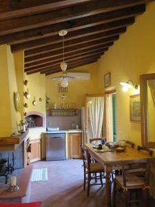 a kitchen with a wooden table and a dining room at Wonderful Rustic Cottage with Garden-Only Adults in Pistoia