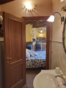 a bathroom with a sink and a room with a bed at Wonderful Rustic Cottage with Garden-Only Adults in Pistoia +13 photos