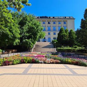 a building with a flower garden in front of it at Bárka Home in downtown Buda in Budapest