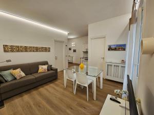 a living room with a couch and a glass table at Appartamento XII Gennaio 3 in Palermo