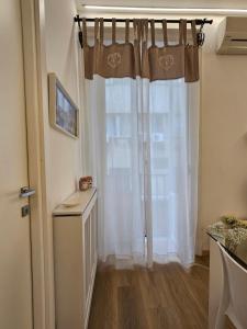 a room with a window with white curtains at Appartamento XII Gennaio 3 in Palermo +22 photos