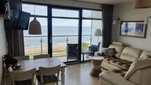 a living room with a view of the ocean at Apartament Marzanna w Willi na Klifie in Rewal